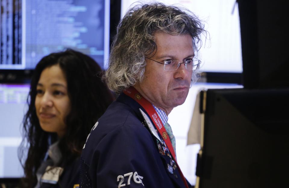 Donald Civitanova, a floor official with Knight Capital, works at the New York Stock Exchange, Thursday, Jan. 2, 2014, in New York. Stocks are opening lower on Wall Street as the market comes off of its biggest annual gain in nearly two decades. (AP Photo/Mark Lennihan)