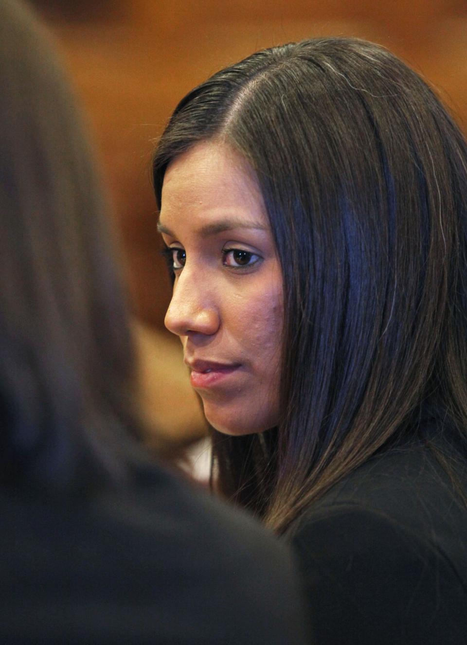 Alexis Wright, 29, turns towards her attorney Sarah Churchill, left, during her arraignment Tuesday, Oct. 9, 2012 in Portland, Maine on 109 counts of prostitution, violation of privacy, tax evasion and other charges for allegedly providing sex for money at her Kennebunk fitness studio and office. Wright pleaded not guilty on charges she ran a prostitution business out of her Kennebunk Zumba studio and secretly filmed her encounters. (AP Photo/Joel Page)