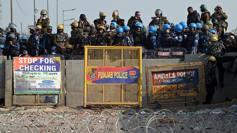 Police and Rapid Action Force (RAF) personnel block a highway to prevent farmers from marching towards New Delhi on February 16, 2024. - Prakash Singh/Bloomberg/Getty Images