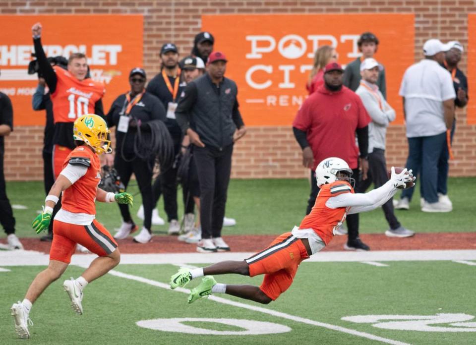 Former Oregon QB Bo Nix (10) cheers on as former Washington State DB Chau Smith-Wade (6) lays out to intercept a pass during the Reese’s Senior Bowl in Mobile, Alabama on Saturday, Feb. 3, 2024. Smith-Wade returned the ball 83 yards and was stopped just before reaching the end zone.