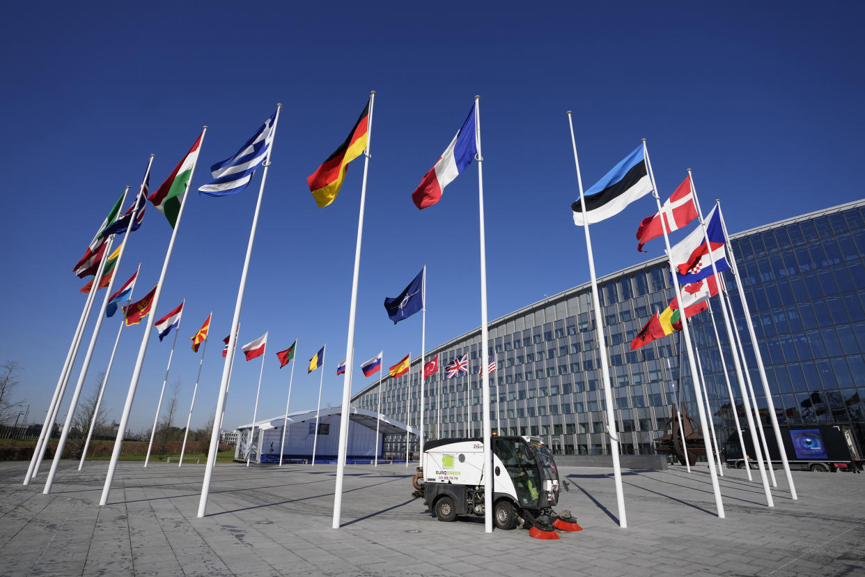 An empty flagpole stands between the national flags of France and Estonia outside NATO headquarters in Brussels, Monday, April 3, 2023. Finland awaits an official green light to become the 31st member of the world's biggest security alliance as NATO foreign ministers prepare to meet in Brussels on Tuesday and Wednesday. (AP Photo/Virginia Mayo)