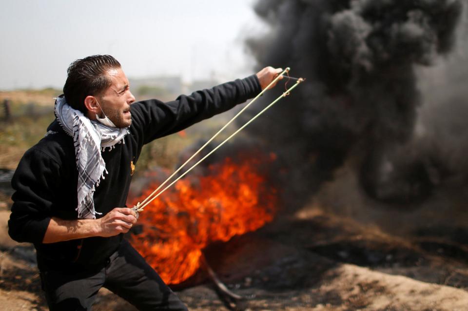 A Palestinian shoots a missile at Israeli troops in the border violence: Reuters