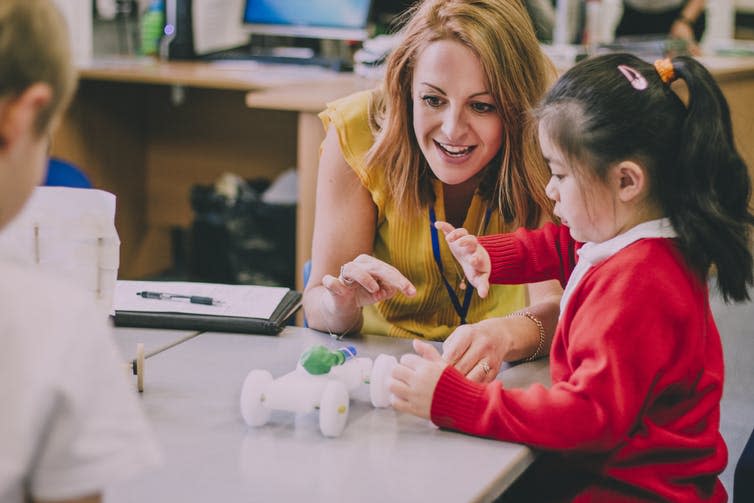 <span class="caption">More money for new teachers, but schools could still financially struggle.</span> <span class="attribution"><a class="link " href="https://www.shutterstock.com/image-photo/teacher-sitting-table-her-classroom-primary-634019516?src=f522c7db-8bfc-4c2d-bdeb-f0221d702275-1-1&studio=1" rel="nofollow noopener" target="_blank" data-ylk="slk:DGLimages/Shutterstock;elm:context_link;itc:0;sec:content-canvas">DGLimages/Shutterstock</a></span>