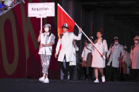 <p>Maskless flag bearers Kanykei Kubanychbekova and Denis Petrashov lead Team Kyrgyzstan. (Photo by Jamie Squire/Getty Images)</p> 