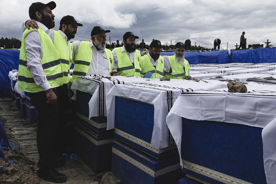 Volunteers perform the final rites before burying the remains of Holocaust victims at a cemetery just outside Brest, Belarus, Wednesday, May 22, 2019. Remains of more than 1,000 Holocaust victims were laid to rest on Wednesday in a Belarusian city on the border with Poland after a mass grave was discovered on a building site earlier this year. (Uladz Hrydzin, Radio Free Europe/Radio Liberty via AP)