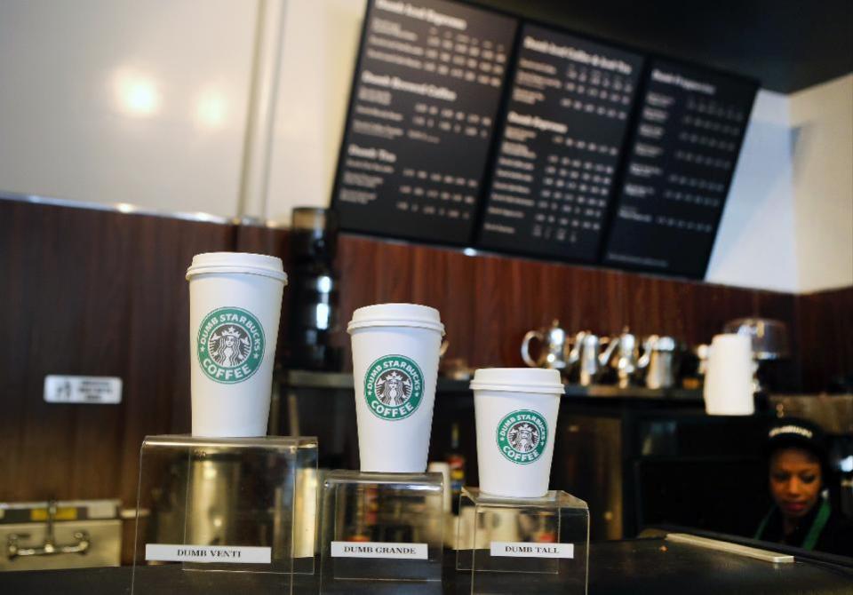 Featured coffee drinks sizes, Dumb Venti, Dumb Grande, and Dumb Tall are displayed inside the Dumb Starbucks in Los Angeles, Monday, Feb. 10, 2014. The mysterious shop named "Dumb Starbucks" is serving coffee in Los Angeles after drawing weekend crowds that waited in a line two blocks long. The line Monday was far shorter, however. The store resembles a Starbucks with a green awning and mermaid logo, but with the word "Dumb" attached above the Starbucks sign. (AP Photo/Damian Dovarganes)