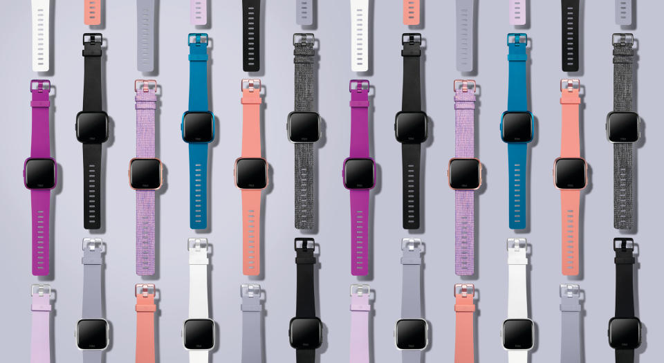 Fitbit's Versa Lite, shown in an array of band colors.