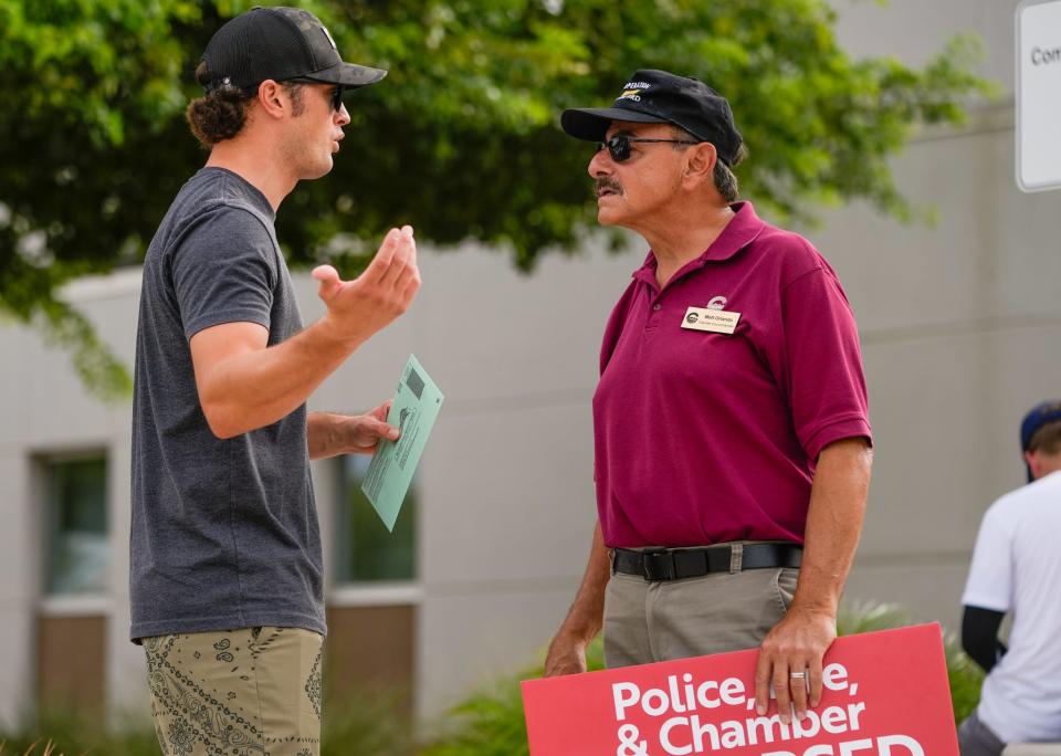 John Guglielmo (left) speaks with Chandler council member Matt Orlando outside of the Chandler Unified School District Office on Aug. 2, 2022.