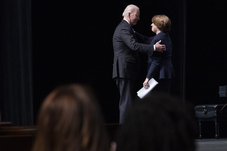 President Joe Biden hugs Sen. Amy Klobuchar, D-Minn., after she spoke at the memorial service for former Vice President Walter Mondale, Sunday, May 1, 2022, at the University of Minnesota in Minneapolis. (AP Photo/Jacquelyn Martin)