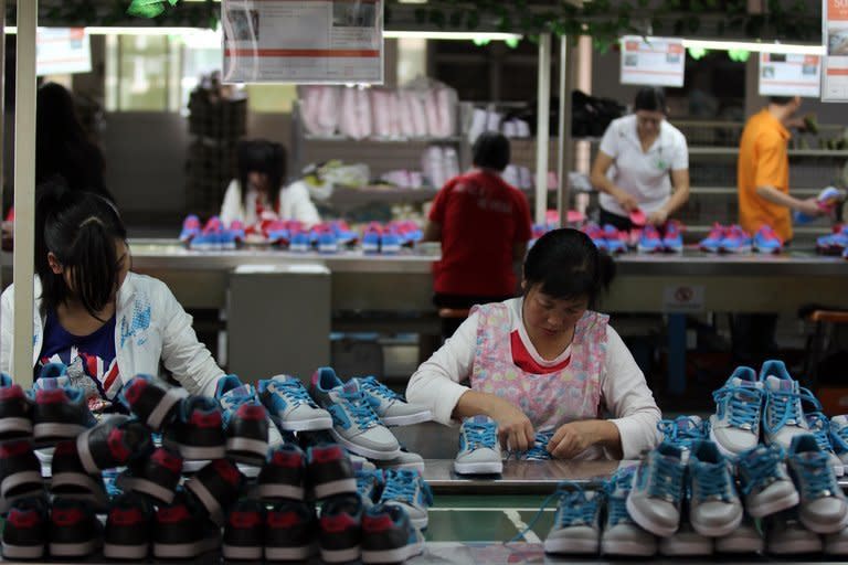 Workers make shoes at a factory in China's Fujian province. There was a double-digit increase in production at factories, workshops and mines for the first time since March, the National Bureau of Statistics said