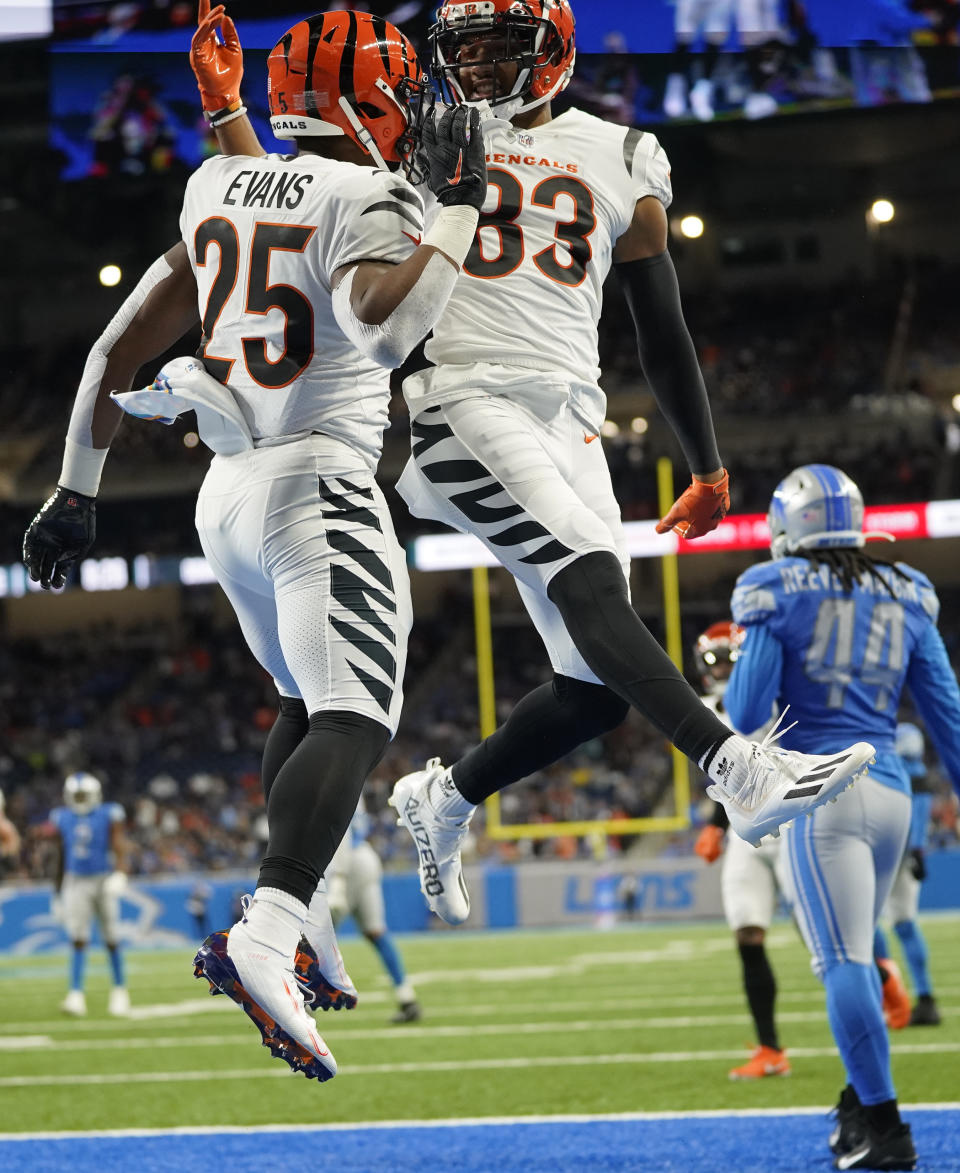 Cincinnati Bengals running back Chris Evans (25) and wide receiver Tyler Boyd (83) celebrate after Evans' touchdown during the first half of an NFL football game against the Detroit Lions, Sunday, Oct. 17, 2021, in Detroit. (AP Photo/Paul Sancya)