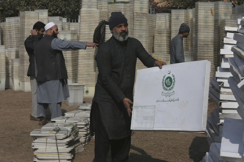 Workers prepare ballot boxes and other materials before dispatching them in polling stations for the upcoming general election on Feb. 8, at an election commission office in Peshawar, Pakistan, Monday, Feb. 5, 2024. (AP Photo/Muhammad Sajjad)