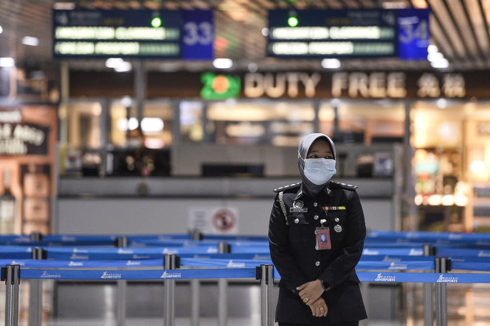 A KLIA safety officer wearing a mask is pictured at KLIA March 10, 2020. — Picture by Miera Zulyana