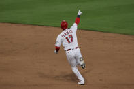 Cincinnati Reds' Kyle Farmer points as he runs the bases after hitting a two-run home run during the sixth inning of the team's baseball game against the Arizona Diamondbacks in Cincinnati, Tuesday, April 20, 2021. (AP Photo/Aaron Doster)