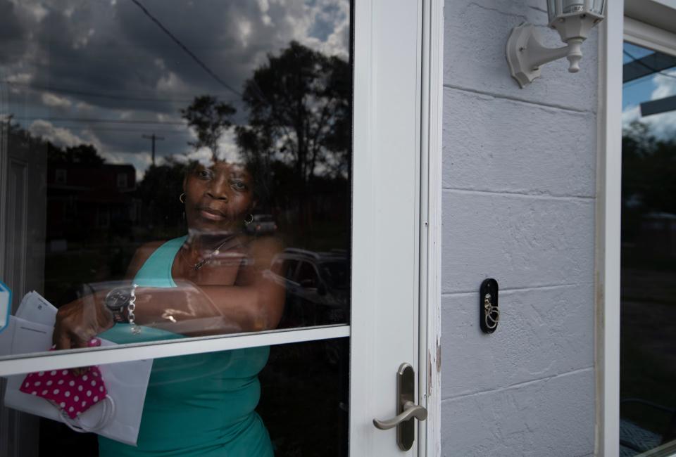 Tracey Watkins looks out the door of her home Tuesday, Aug. 25, 2020 Nashville, Tenn. While trying to repair her home after the March 3 tornado, Watkins has had to navigate financial hurdles, like fighting with her insurance company to cover repair costs.