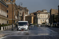 A street cleaner truck sprays disinfectant on a street to avoid the spread of Covid-19 virus, in central Rome, Wednesday, April 8, 2020. The new coronavirus causes mild or moderate symptoms for most people, but for some, especially older adults and people with existing health problems, it can cause more severe illness or death. (Cecilia Fabiano/LaPresse via AP)