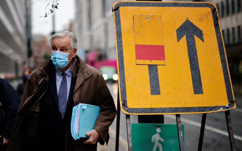 EU chief negotiator Michel Barnier, wearing a protective face covering to combat the spread of the coronavirus, walks to a conference centre in central London on Thursday - AFP