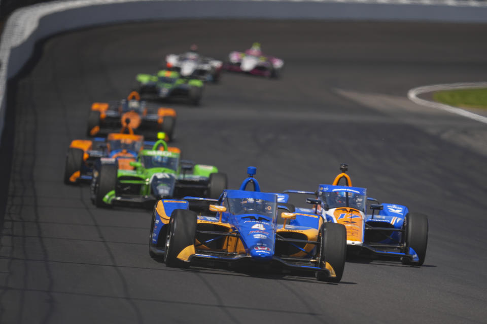 Kyffin Simpson (4) passes Kyle Larson (17) as he drives into the second turn during the final practice for the Indianapolis 500 auto race at Indianapolis Motor Speedway in Indianapolis, Friday, May 24, 2024. (AP Photo/Michael Conroy)