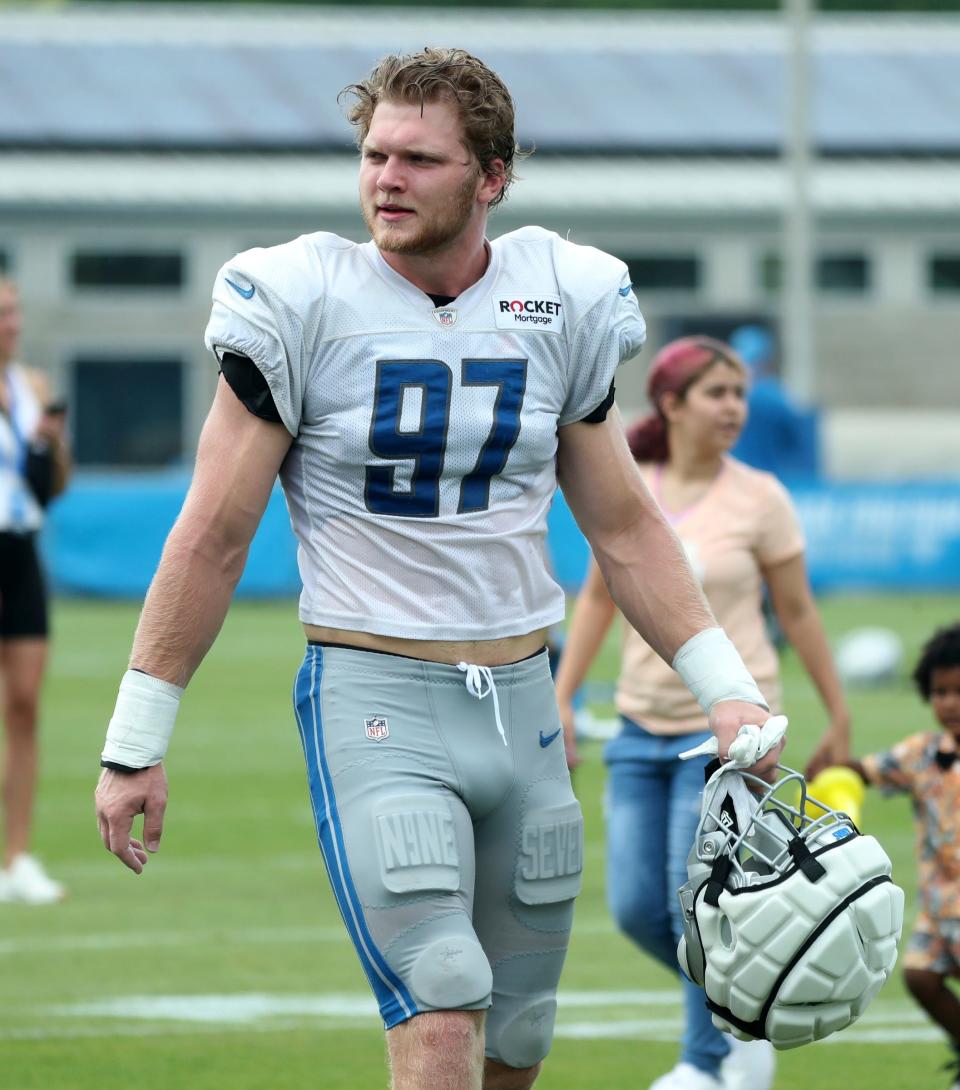 Detroit Lions defensive end Aidan Hutchinson (97) walks off the field after training camp at team headquarters in Allen Park on Friday, July 28, 2023.
