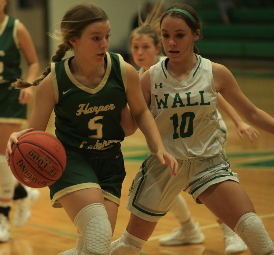 Harper High School's Brittany Evans, 5, drives toward the basket as Wall's Brylyn Watts defends during a game at the Wall gym on Tuesday, Nov. 30, 2021.