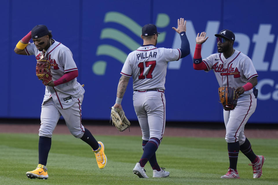 Atlanta Braves' outfielders Ronald Acuna Jr., left, Kevin Pillar, center, and Michael Harris II celebrate after the first baseball game of a doubleheader against the New York Mets at Citi Field, Monday, May 1, 2023, in New York. (AP Photo/Seth Wenig)