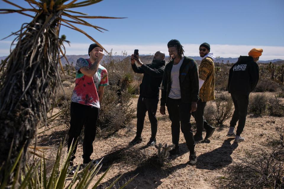 Bobby Brown, left, and members of Donuts With Dads take a walk among Joshua trees.