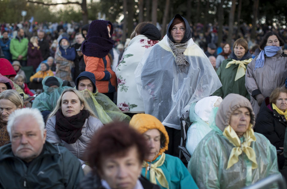 Faithful gather to follow Pope Francis' celebrating Holy Mass at the Confluence Park in Kaunas, Lithuania, Sunday, Sept. 23, 2018. Pope Francis is on the second of his two-day visit to Lithuania. (AP Photo/Mindaugas Kulbis)