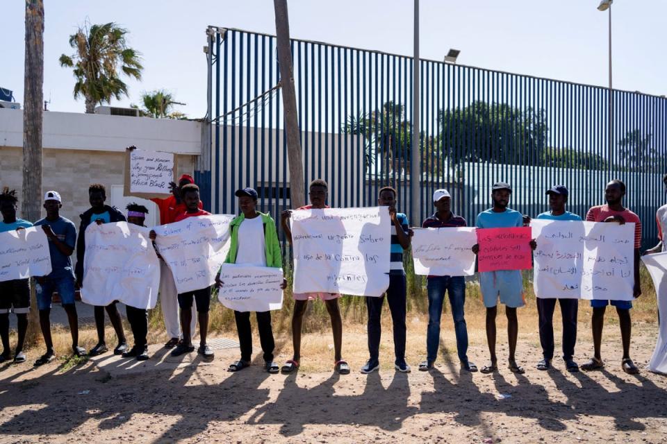 Protesters gather outside Melilla’s short-stay migrants centre in June (Reuters)