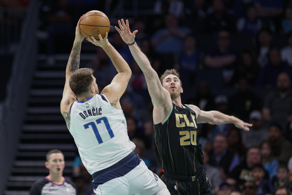 Dallas Mavericks guard Luka Doncic (77) shoots over Charlotte Hornets forward Gordon Hayward during the first half of an NBA basketball game in Charlotte, N.C., Sunday, March 26, 2023. (AP Photo/Nell Redmond)