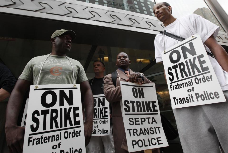 Striking Southeastern Pennsylvania Transportation Authority police officers picket outside the transit agency's offices Wednesday, March 21, 2012, in Philadelphia. (AP Photo/Matt Rourke)