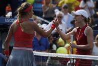 Victoria Azarenka of Belarus (L) is congratulated by Alize Cornet of France after Azarenka won their match at the U.S. Open tennis championships in New York August 31, 2013. REUTERS/Kena Betancur