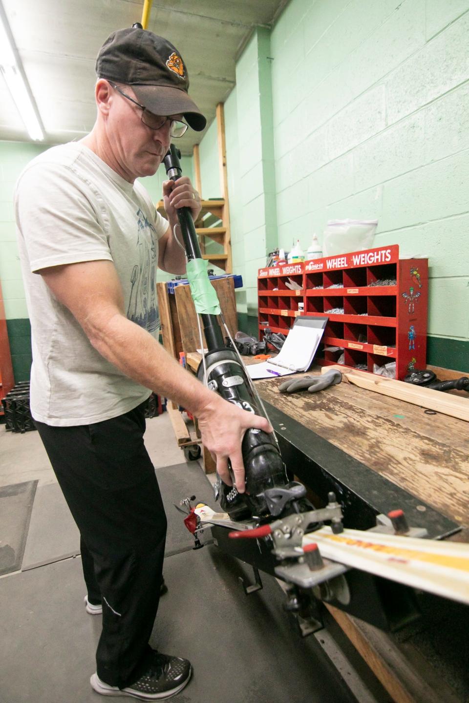 Rental lead Mike Millhouse checks the binding Monday, Nov. 14, 2022 on one of 940 sets of rental skis currently on hand at Mt. Brighton as part of the tuning process all rental skis put through. With additional skis ordered, the shop will have 1200 pairs to rent.