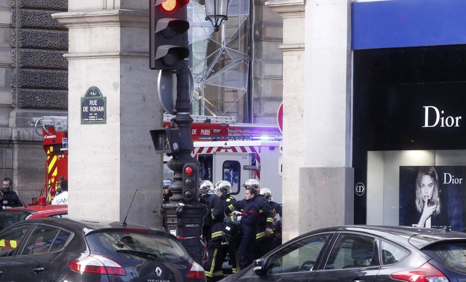 Rescue workers carry a stretcher outside the Louvre museum in Paris,Friday, Feb. 3, 2017. Paris police say a soldier has opened fire outside the Louvre Museum after he was attacked by someone, and the area is being evacuated. (AP Photo/Thibault Camus)