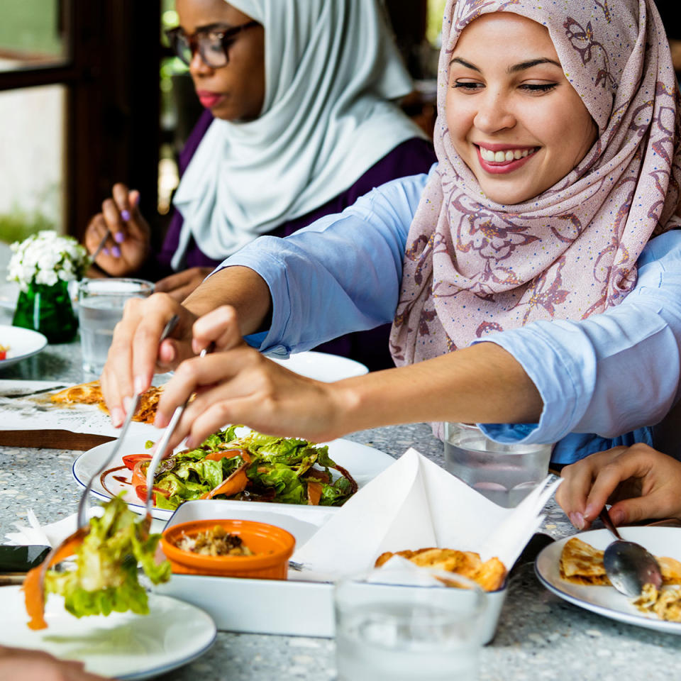 Woman serving brunch with friends