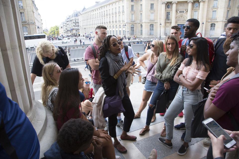 In this photo provided by Centenary College of Louisiana, associate professor Andia Augustin-Billy gives a lecture outside the Pantheon in Paris on Aug. 11, 2018, while teaching as part of Centenary College's Centenary in Paris program for first-year students. At 196 years Louisiana's oldest college, Centenary plans a gathering Thursday, Nov. 4, 2021, to honor Augustin-Billy as the first Black to gain tenure there. (Sherry Heflin/Centenary College of Louisiana via AP)