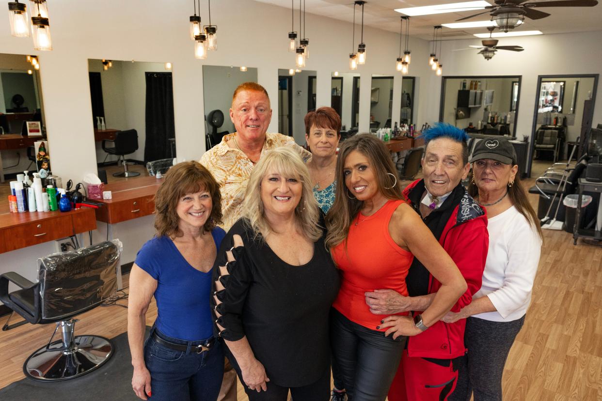 Justine Talarico, owner, (center, in black) and her long-time staff at Just Hair & Nails in Oceanport, (left to right) Pam Hollander, Paul Connelly, Bunni Carroll, Geogea Scarpino, Thomas Blackburn and Linda Mihalic.