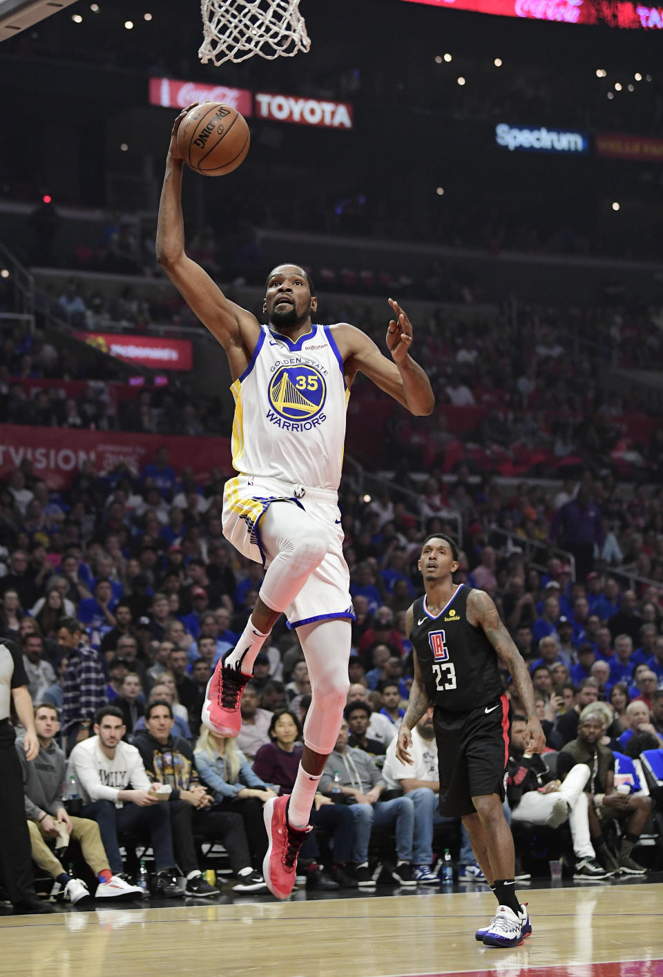 Golden State Warriors forward Kevin Durant, left, shoots as Los Angeles Clippers guard Lou Williams defends during the first half in Game 6 of a first-round NBA basketball playoff series Friday, April 26, 2019, in Los Angeles. (AP Photo/Mark J. Terrill)