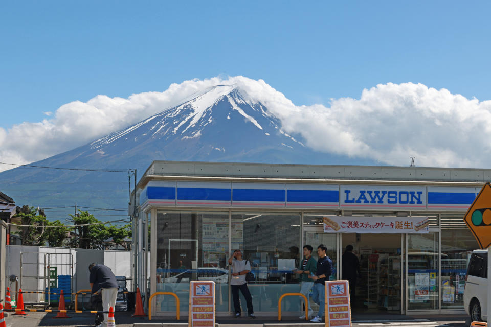 Warning signs printed in multiple languages in front of the Lawson store, which has become a tourist hotspot.<span class="copyright">LewisTsePuiLung—Getty Images</span>