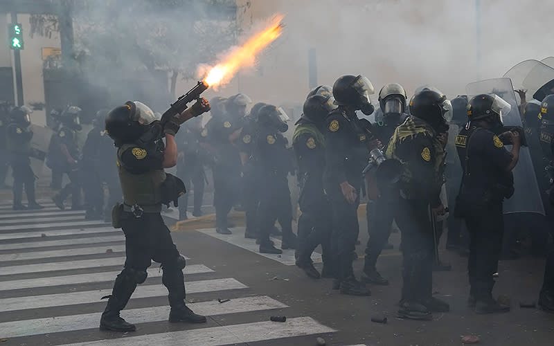 Police fire tear gas at anti-government protesters in downtown Lima, Peru, on Jan. 24. Protesters are seeking the resignation of President Dina Boluarte, the release from prison of ousted President Pedro Castillo, immediate elections and justice for demonstrators killed in clashes with police. <em>Associated Press/Martin Mejia</em>