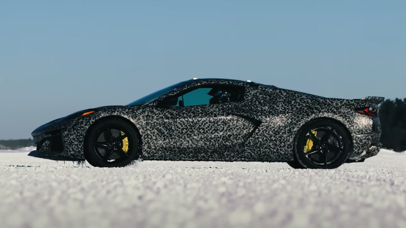 side view of a corvette prototype in black and white camouflage on a snow covered test track