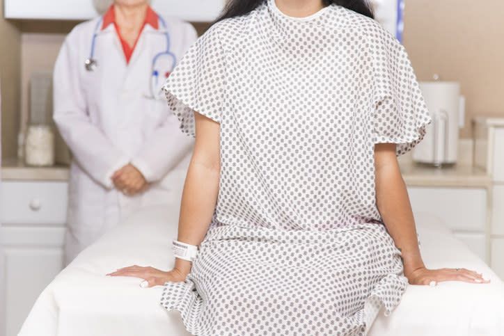 A woman at the doctor's office, sitting on an exam table