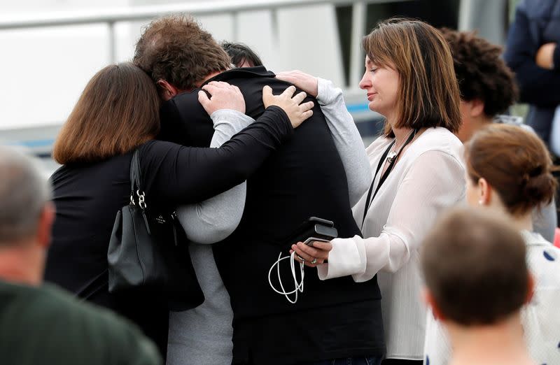 Relatives hug as they wait for rescue mission, following the White Island volcano eruption in Whakatane
