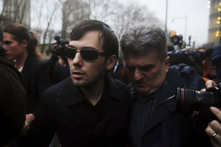 Martin Shkreli (C), chief executive officer of Turing Pharmaceuticals and KaloBios Pharmaceuticals Inc, departs U.S. Federal Court after an arraignment following his being charged in a federal indictment filed in Brooklyn relating to his management of hedge fund MSMB Capital Management and biopharmaceutical company Retrophin Inc. in New York December 17, 2015. REUTERS/Lucas Jackson