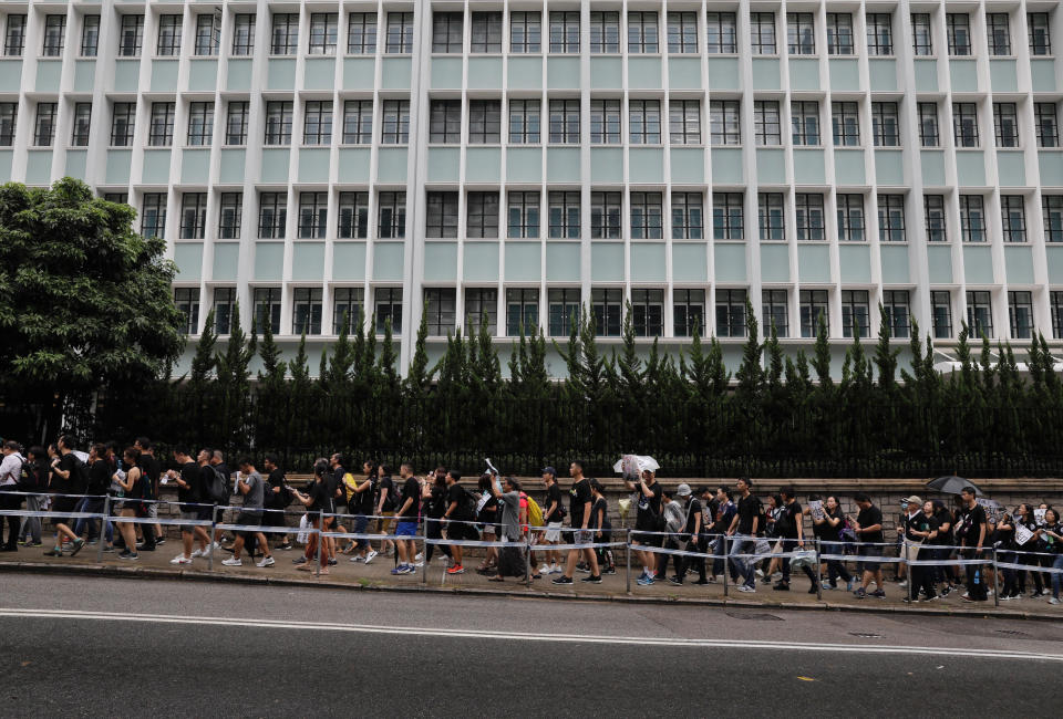 Pro-democracy protesters march organized by teachers in Hong Kong Saturday, Aug. 17, 2019. Members of China's paramilitary People's Armed Police marched and practiced crowd control tactics at a sports complex in Shenzhen across from Hong Kong in what some interpreted as a threat against pro-democracy protesters in the semi-autonomous territory. (AP Photo/Vincent Yu)