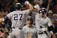 New York Yankees' Giancarlo Stanton (27) celebrates his two-run home run with Joey Gallo, right, that also drove in Aaron Judge, center, during the eighth inning of a baseball game, Sunday, Sept. 26, 2021, in Boston. (AP Photo/Michael Dwyer)