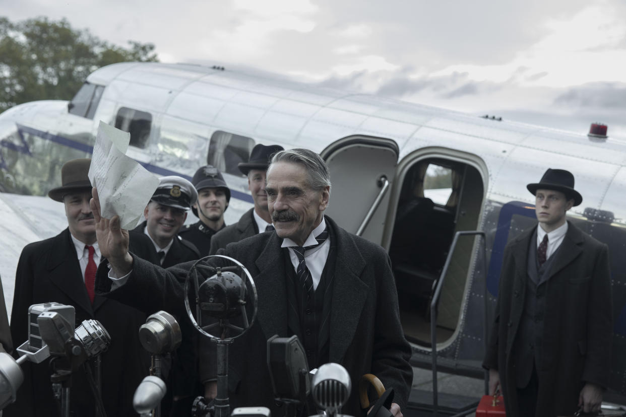 Munich - The Edge of War. (L to R) Jeremy Irons as Neville Chamberlain, George MacKay as Hugh Legat, in Munich - The Edge of War. Cr. Courtesy of Netflix © 2021