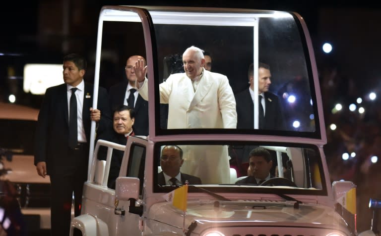 Pope Francis waves to well-wishers from the Popemobile upon his arrival in Mexico City, on February 12, 2016