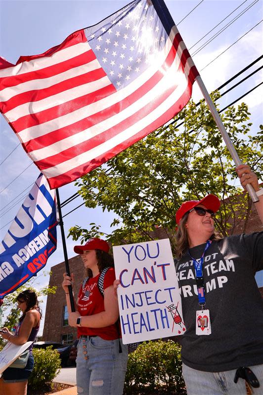 Trump supporters with the MYSCGOP group, including Nicole Morgan, right, and her daughter McKenna Morgan, left, protest as Vice President Kamala Harris visits Greenville Monday morning.