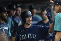 Seattle Mariners' Cal Raleigh is congratulated by teammates in the dugout after hitting a solo home run during the fifth inning of a baseball game against the Baltimore Orioles, Monday, June 27, 2022, in Seattle. (AP Photo/Stephen Brashear)