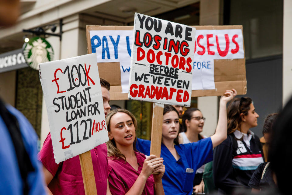 LONDON, UNITED KINGDOM - 2022/07/25: Medical students hold placards expressing their opinion during the demonstration outside the Department of Health and Social Care. NHS doctors, nurses, and other allied healthcare professionals gathered outside the Department of Health and Social Care, demanding a pay rise to match the inflation rate. The crowds later marched to Downing Street and demanded the government respond to their demands or else will plan for industrial actions in the coming months. (Photo by Hesther Ng/SOPA Images/LightRocket via Getty Images)